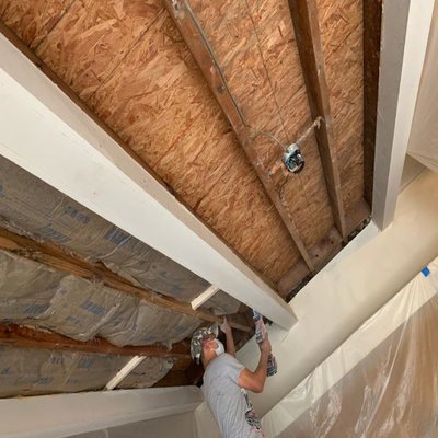 Done Right Drywall — crew installing a cathedral-ceiling drywall framing pattern with exposed studs and insulation